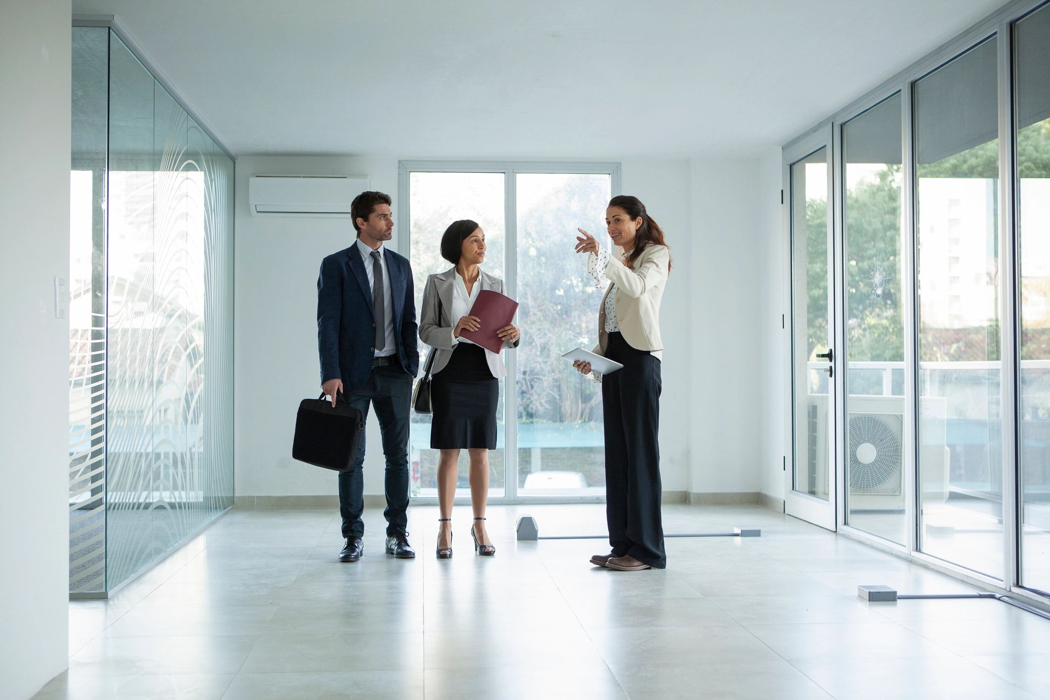 Real estate professionals meeting with clients in a modern office